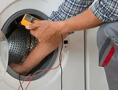 Washing machine repair technician testing a front-load washer with diagnostic tools in Long Beach, CA